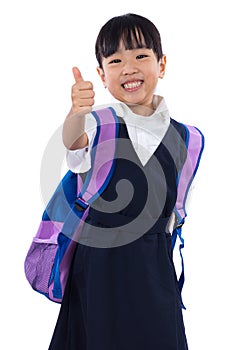 Asian Chinese little primary school girl showing thumbs up