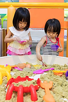 Asian Chinese Little Sister Playing Kinetic Sand Indoor