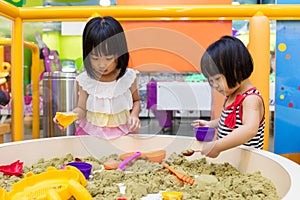 Asian Chinese Little Sister Playing Kinetic Sand Indoor
