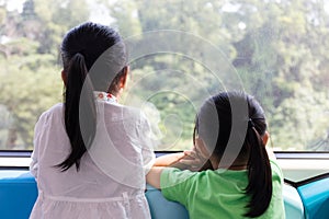 Asian Chinese little sisters inside a MRT transit