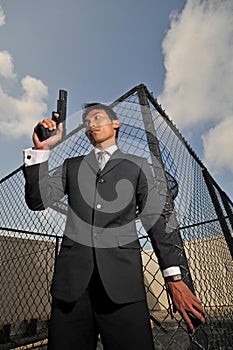 Asian Chinese Man carrying a Pistol