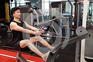 Asian chinese man in gym ï¼ŒFitness man doing triceps exercises in the gym. Attractive, adult.