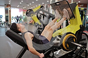 Asian chinese man in gym ï¼ŒFitness sport man Training of leg strength in the gym
