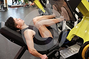 Asian chinese man in gym ï¼ŒFitness sport man Training of leg strength in the gym