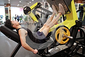 Asian chinese man in gym ï¼ŒFitness sport man Training of leg strength in the gym