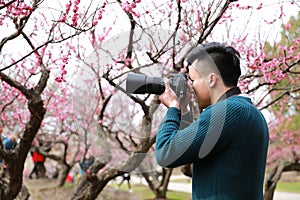 Asian chinese man photographer in nature