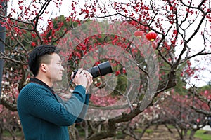 Asian chinese man photographer in nature