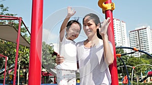 Asian chinese mother and child giving a high five to each other