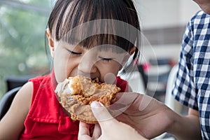 Asian Chinese mother and daughter eating fried chicken