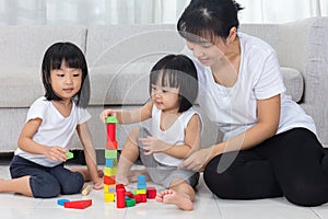 Asian Chinese mother and daughter playing blocks on the floor