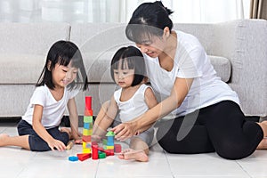 Asian Chinese mother and daughter playing blocks on the floor