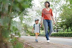 Asian Chinese Mother walking with a little son