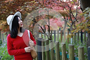 Asian Chinese pretty woman smiling and walking in nature in spring outdoor