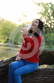 Asian Chinese pretty woman smiling and walking in nature in spring outdoor