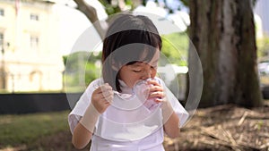 Asian chinese single child girl eating ice cream hungrily for the first time