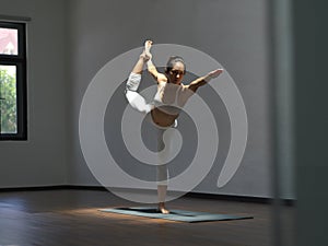 Asian chinese single woman in spotlight practising Yoga