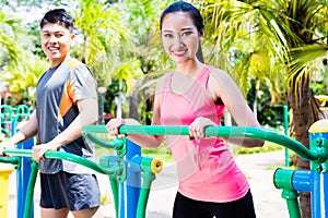 Asian Chinese sport friends in outdoor fitness gym
