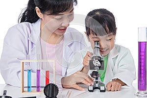 Asian Chinese teacher and little student girl working with micro