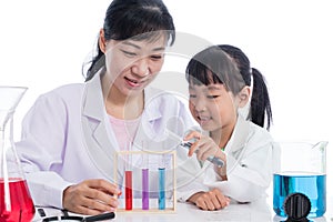 Asian Chinese teacher and little student girl working with test