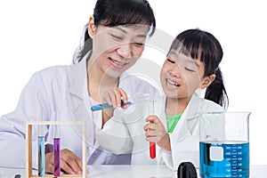 Asian Chinese teacher and little student girl working with test