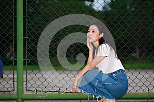 Asian Chinese university student play on the Tennis court playground