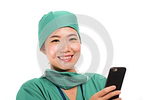 Asian Chinese woman as successful physician using hand phone - young beautiful and happy medicine doctor or chief hospital nurse