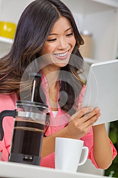 Asian Chinese Woman Girl in Kitchen Using Tablet Computer