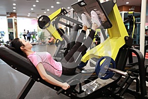 Asian chinese woman in gym ï¼ŒFitness sport woman Training of leg strength in the gym