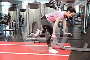 Asian chinese woman in gym ï¼ŒFitness young girl in the gym doing exercises with dumbbells