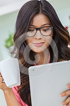 Asian Chinese Woman Using Tablet Computer Drinking Coffee or Tea