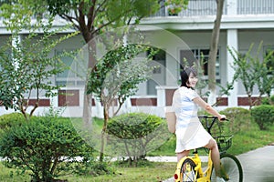Asian Chinese Young beautiful, elegantly dressed woman with Sharing bicycle. Beauty, fashion and lifestyle