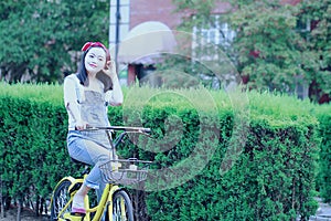 Asian Chinese Young beautiful, elegantly dressed woman with Sharing bicycle. Beauty, fashion and lifestyle
