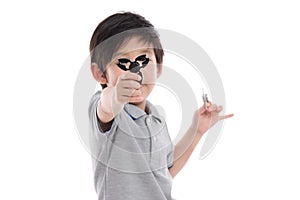 Asian chld holding two fidget spinners
