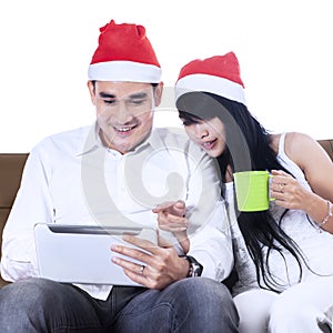 Asian christmas couple shopping online