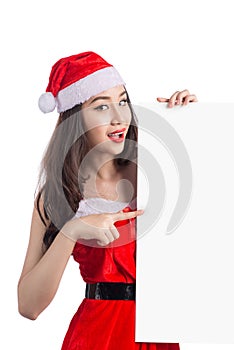 Asian Christmas girl with Santa Claus clothes holding blank sign