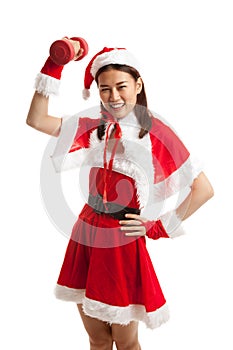 Asian Christmas girl with Santa Claus clothes and red dumbbell.