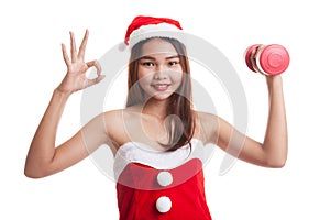 Asian Christmas Santa Claus girl show Ok with red dumbbell.
