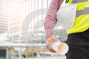 Asian civil engineer working at building site.