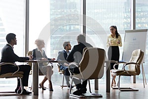 Asian coach giving business presentation at board multi-ethnic team meeting photo