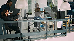 Asian coder with physical disability working with african american developer