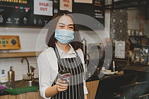 Asian coffee shop business women use modern barcode scanners for convenience and modernity.