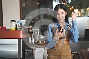 Asian Coffee Shop Owner Accepts a Pre-Order on a Tablet Happy Smiling to the Customer in a Cozy Cafe. Restaurant Manager Browsing