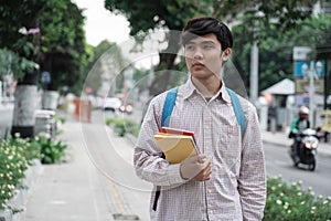 Asian collage boy holding a book