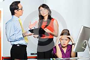 Asian colleagues mobbing or bullying employee