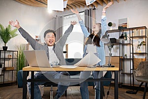 Asian colleagues students throwing papers after successful meeting or exam pass