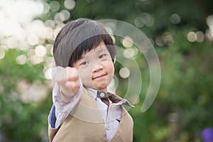 Asian confidence child shows his hand