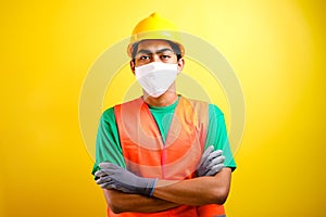 Asian constructor worker man with mask and safety vest crossed his arm photo