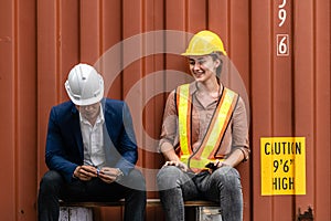 Asian Container Depot chief talking to Caucasian  female foreman about while break