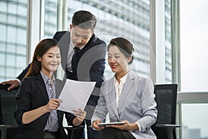 asian corporate executives discussing business in office