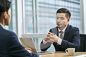 asian corporate executives discussing business in office